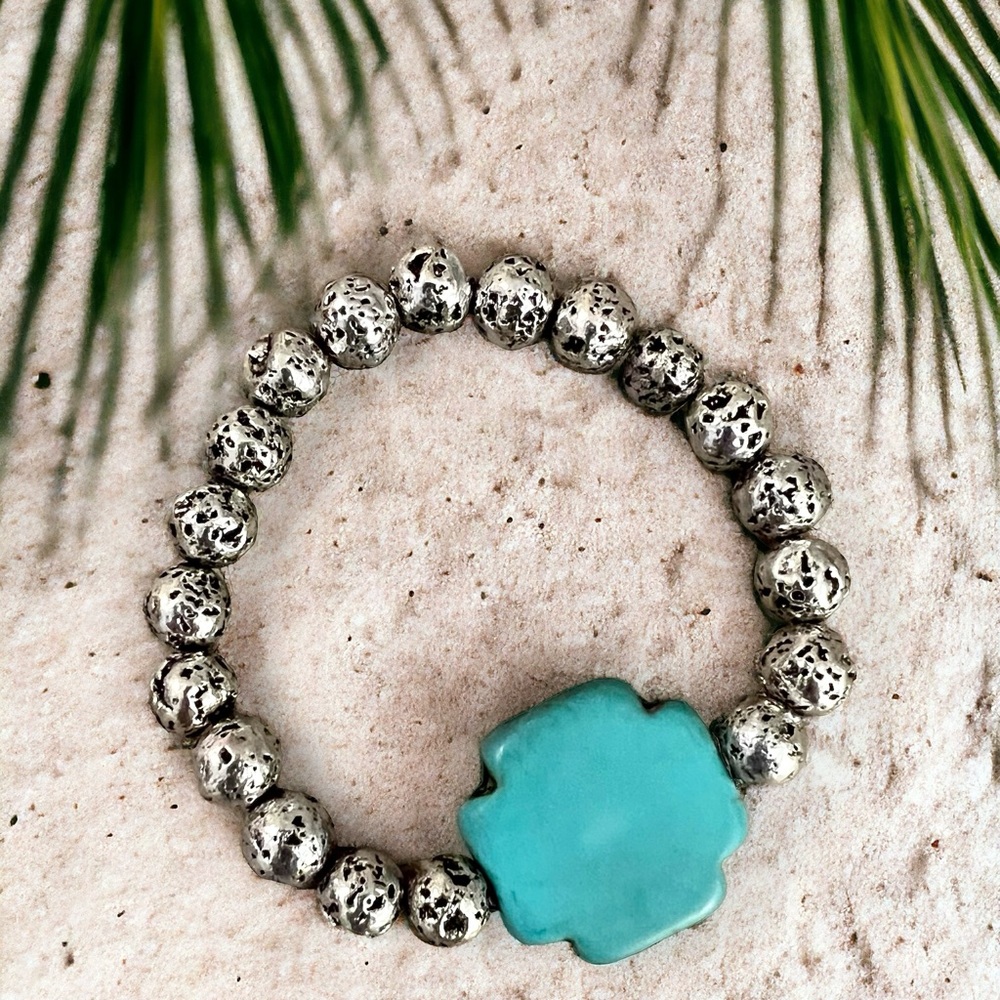 AGIA BRACELET Featuring a genuine turquoise howlite cross on silver lava stone